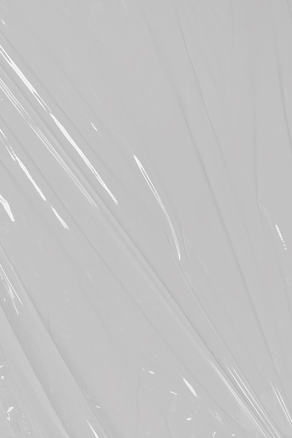 Foto gekneusde kunststofwarp grunge kunststoffolie op witte achtergrond textuur transparante uitgerekte film polyethyleen
