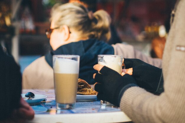 Foto geknipte afbeelding van een persoon die ijskoffie drinkt in een restaurant