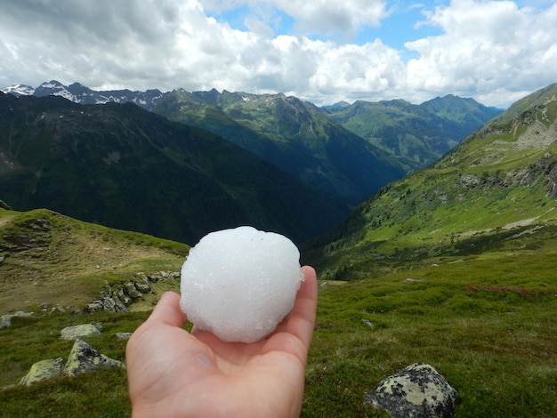 Foto geknipte hand met ijs tegen bergen