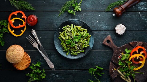 Gekookte groene aspergeboon in een zwarte plaat Bovenaanzicht Gratis exemplaarruimte