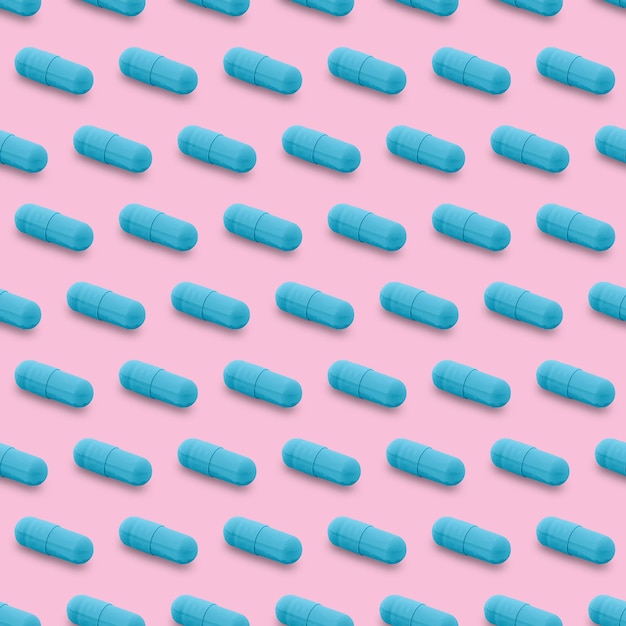 Photo gel capsule seamless pattern blue capsule drug pharmacy concept food supplement on pink