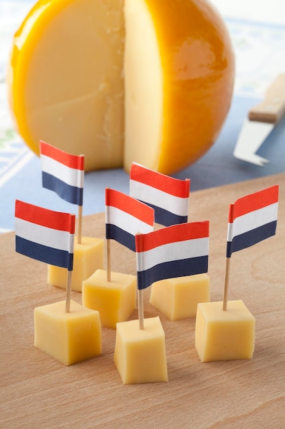 Foto gele edammer kaasblokken met nederlandse vlaggetjes