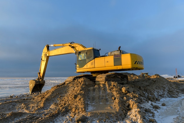 Gele graafmachine bezig met bouwplaats. De wegenbouw.