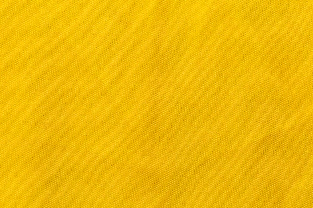 Gele kleur sportkleding stof voetbalshirt jersey textuur en textiel achtergrond