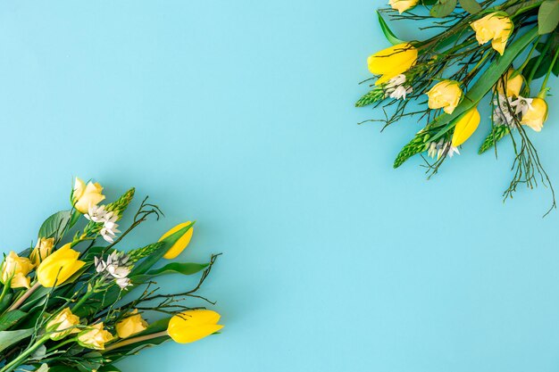 Gele tulpen op een blauwe achtergrond plat gelegd