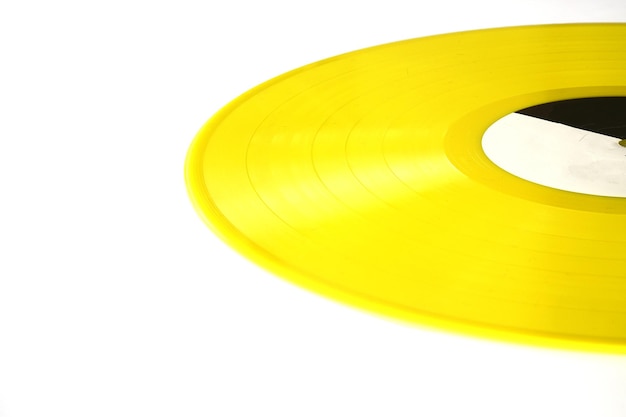 Foto gele vinylplaat op een witte achtergrond retro-stijl bovenaanzicht plat lag kopieerruimte