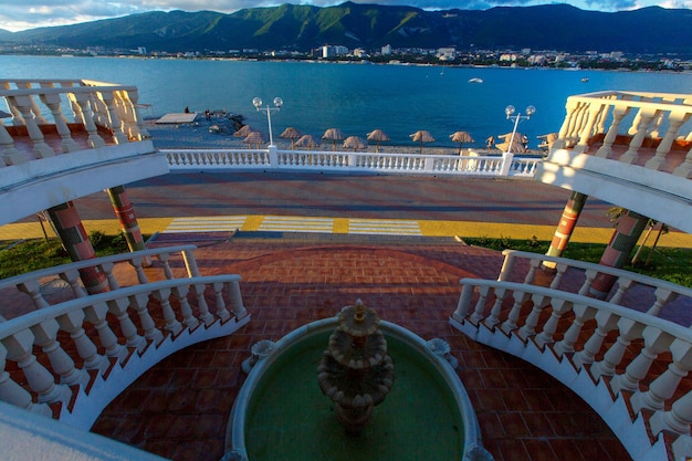 Gelendzhik Embankment at sunset  Elegant balustrade and fountain in the foreground Gelendzhik Bay