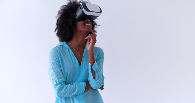 Gelukkig Afrikaans Amerikaans meisje dat ervaring opdoet met het gebruik van een VR-headsetbril van virtual reality, geïsoleerd op een witte achtergrond