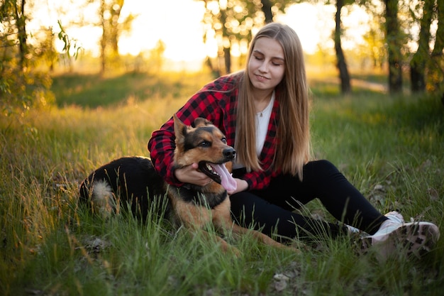 Gelukkig blond meisje wordt gespeeld met een hond.