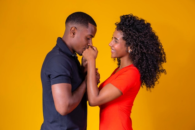 Gelukkig en liefdevol afro paar op gele achtergrond Valentijnsdag