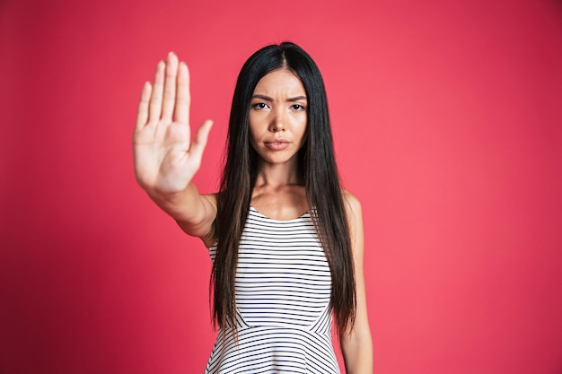 Gelukkig en opgewonden mooie jonge Aziatische vrouw portret geïsoleerd op roze achtergrond. Mensen emoties concept