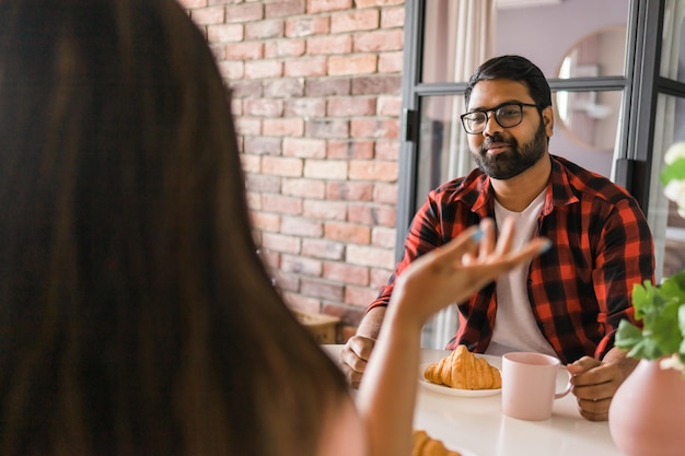 Gelukkig Indisch stel aan het ontbijt en een praatje samen in de keuken, vriendschap dating en fa