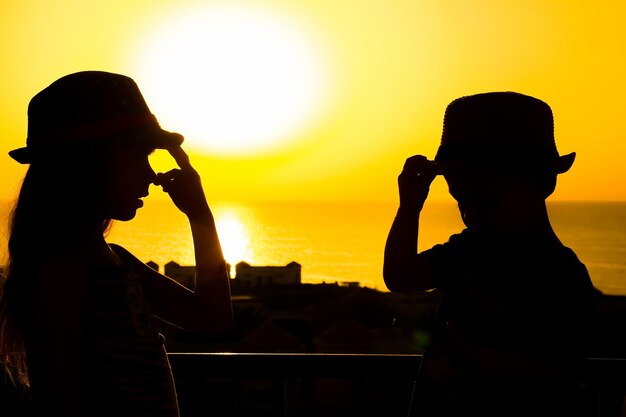 Gelukkig kind in hoed silhouet op zee achtergrond