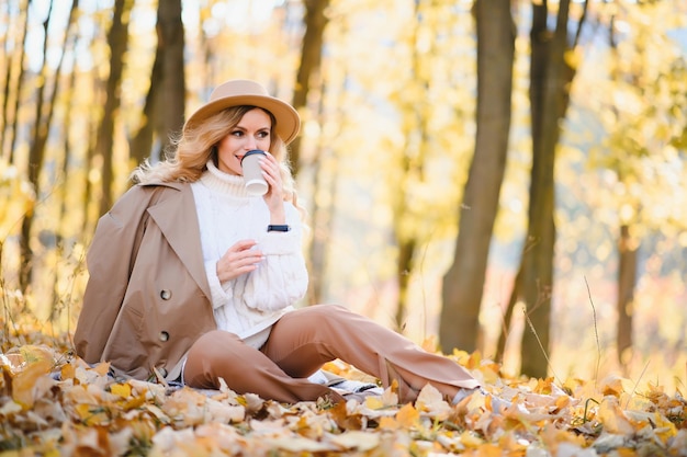 Gelukkig lachende jonge vrouw in park op herfstdag