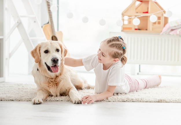 Gelukkig meisje die mooie hond knuffelen