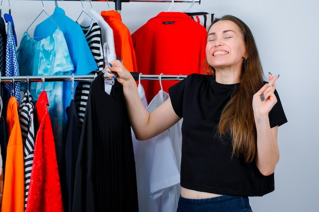 Gelukkig meisje houdt zwarte jurk op kleding achtergrond