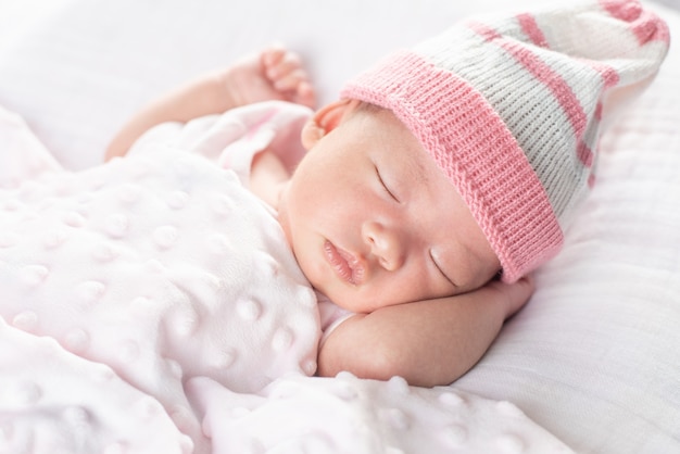 Foto gelukkig schattige baby meisje slapen in wieg. klein kind met dag dutje in bed van de ouders