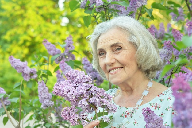 Gelukkig senior mooie vrouw met seringen