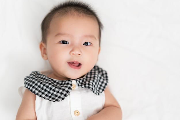 Gelukkige baby pasgeboren op een bed