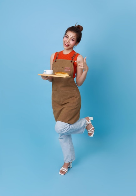 Gelukkige barista Aziatische vrouw die klanten bedient met een koffiekop in een koffiewinkel