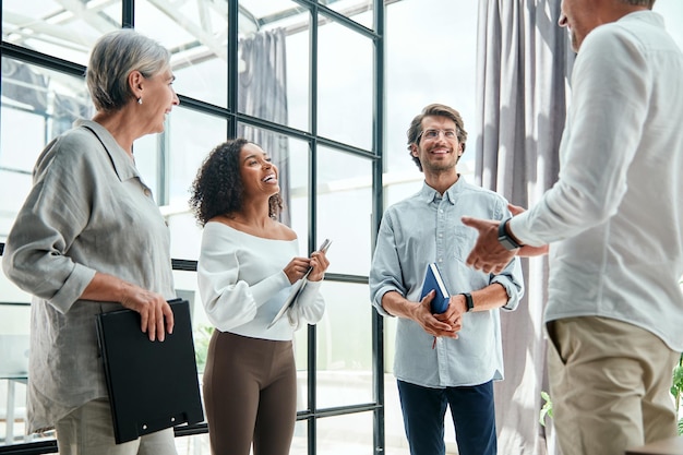 Gelukkige collega's die de goede nieuwsclose-up bespreken