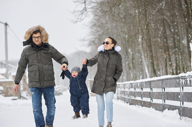 Gelukkige familie plezier buiten in de buurt van het huis in de winter