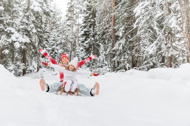 Gelukkige familie plezier buiten Moeder en kind spelen in de winter Actieve gezonde levensstijl