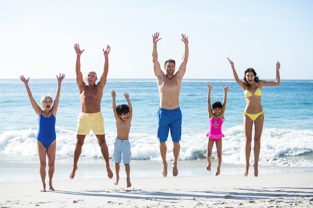 Gelukkige familie springen op het strand