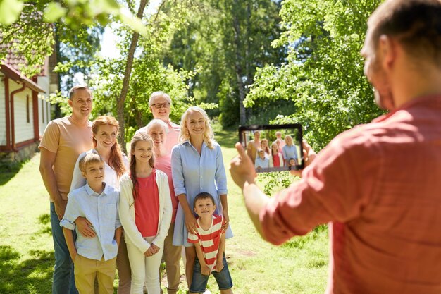 Gelukkige familiefotograferen met een tablet in de zomer