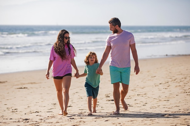 Gelukkige familievakanties Vader moeder en zoon kind wandelen op zandstrand Zomervakanties met kinderen