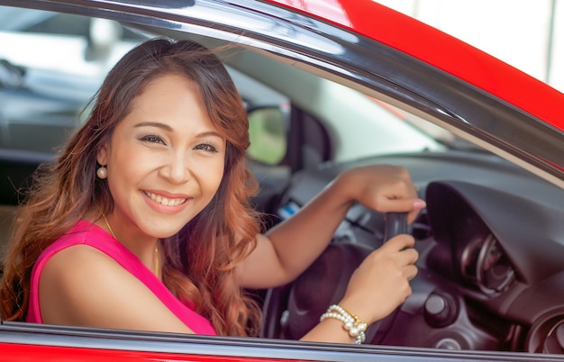 Gelukkige glimlachende vrouw met autosleutel. Het rijden