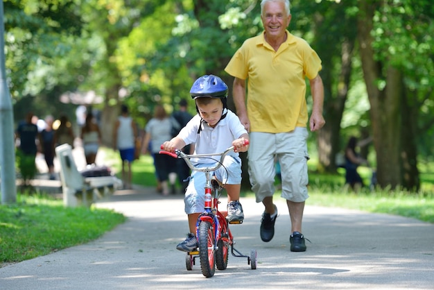 gelukkige grootvader en kind hebben plezier en spelen in het park