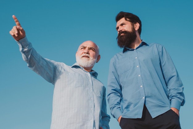 Gelukkige grootvader en vader over blauwe lucht en wolken achtergrond mannen generatie pensioen ouder ag