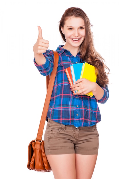 Gelukkige jonge de holdingsboeken van het studentenmeisje, middelbare school of universiteitsafstudeerder, het leuke toevallige tiener glimlachen