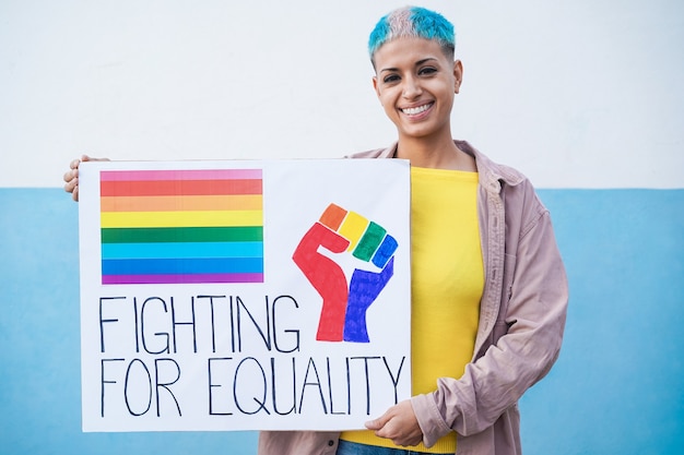 Gelukkige lesbische vrouw die bij gay pride-parade lgbt-banner houdt