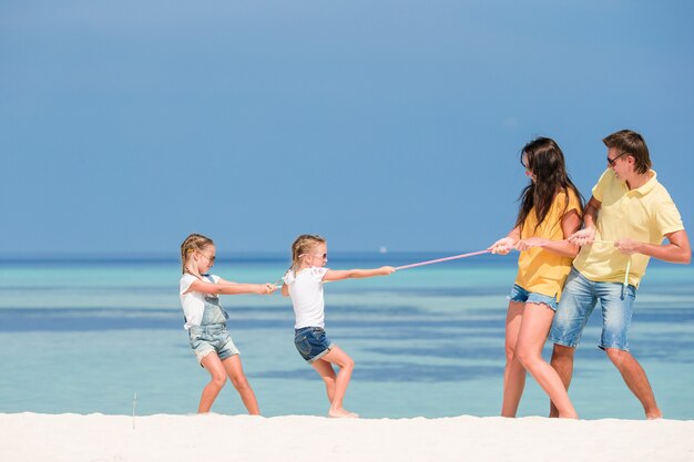 Gelukkige mooie familie op een strand tijdens de zomervakantie