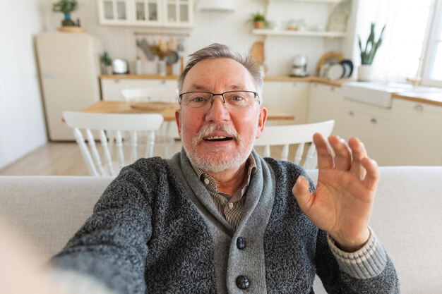 Gelukkige oudere man van middelbare leeftijd praat op videogesprek met vrienden familie lacht volwassen oude oudere grootvader