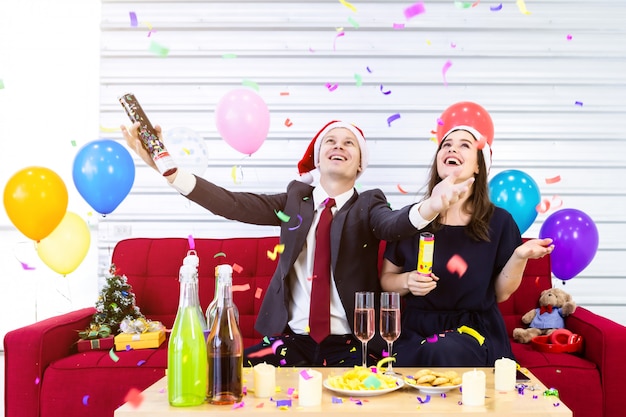 Gelukkige paar vieren Kerstmis met een feestje met ballonnen