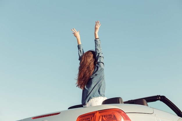 Foto gelukkige reizigersvrouw in cabrioauto