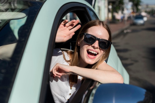 Gelukkige vrouw in auto die gaat reizen