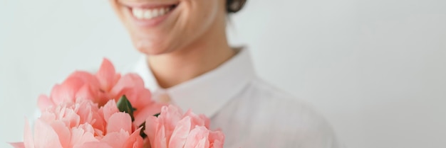 Gelukkige vrouw met een boeket pioenrozen