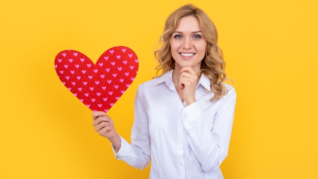 Gelukkige vrouw met rood liefdeshart op gele achtergrond lieverd