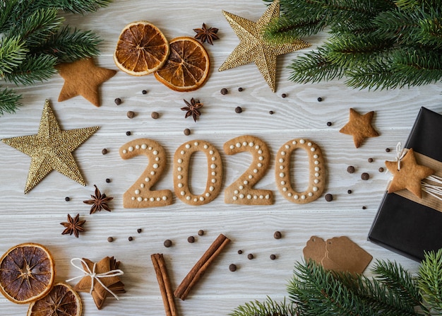 Gemberkoekjes in de vorm van getallen en 2020 nieuwjaar gemberkoekjes wit hout. Bovenaanzicht Seizoensgebonden verpakkingen, kruiden en Nieuwjaarsattributen