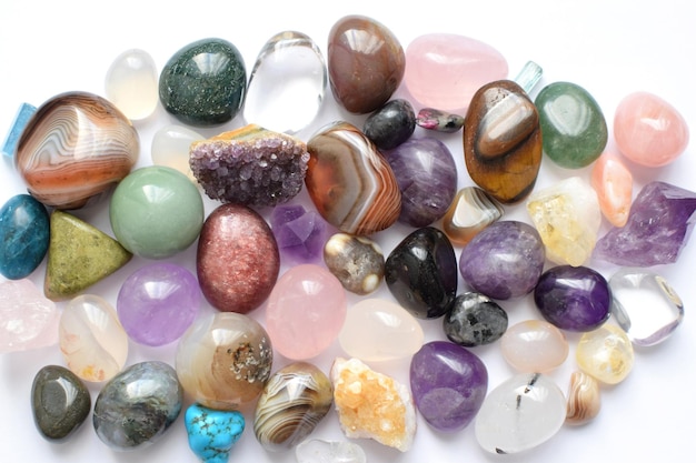 Gems of various colors Amethyst rose quartz agate apatite aventurine olivine turquoise aquamarine rock crystal on white background