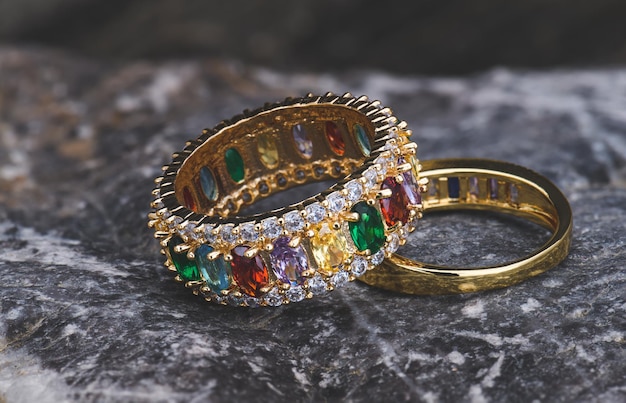 Gemstone jewelry golden ring with nature stone texture in studio lighting.