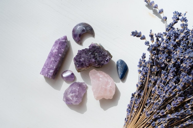 Gemstones minerals stones and obelisks with lavender flowersWitchcraft herbal medicine and healing Magic healing Rock for Reiki Crystal Ritual Witchcraft spiritual esoteric practice
