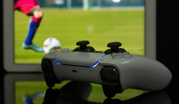 Next Gen game controller with football game at screen