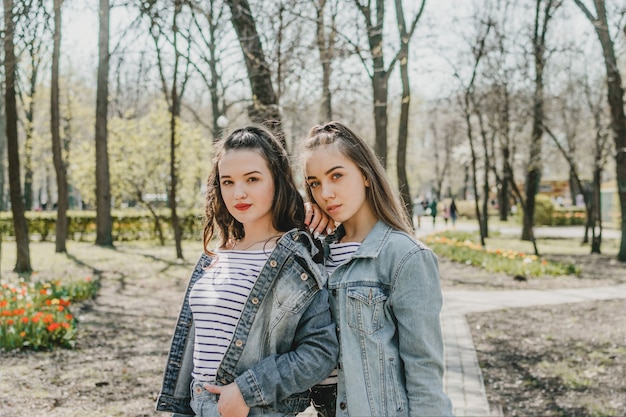 Gen z girls enjoying outdoors expressing positive emotions outdoor photo of two girl friends having