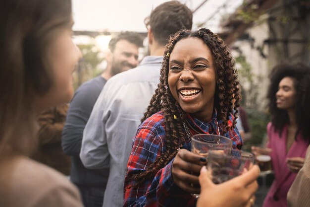 Gen z young people having fun dancing and bonding together at the university rooftop party