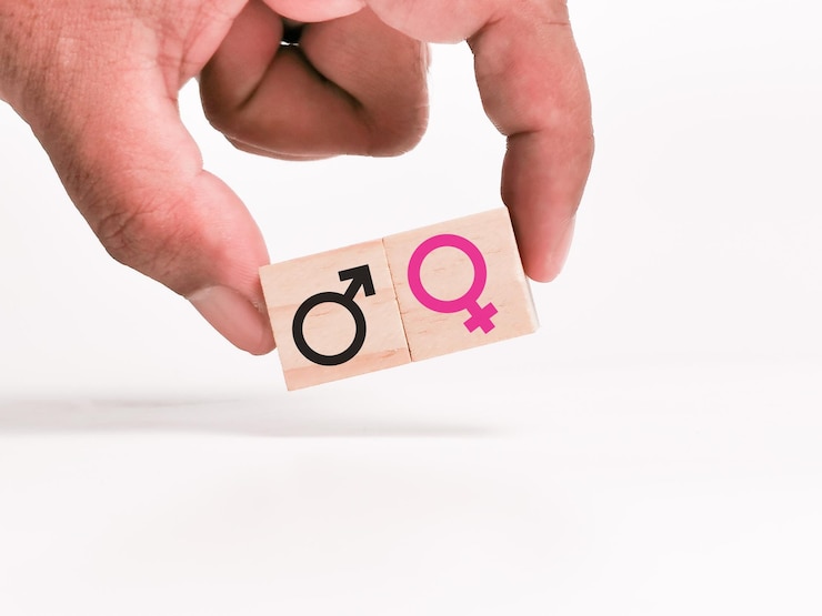 Photo gender equality concept with hand holding wooden cube.